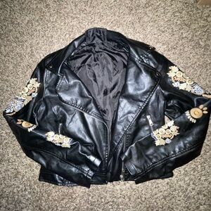 Faux leather jacket with embroidery detailing on sleeves.